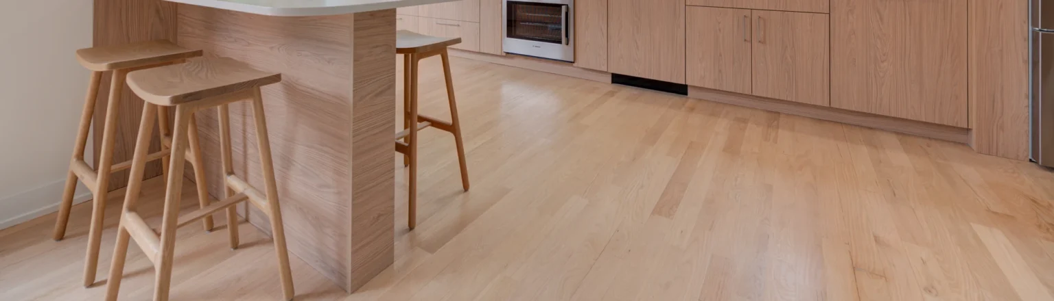 Light wood flooring in a kitchen with wood cabinetry